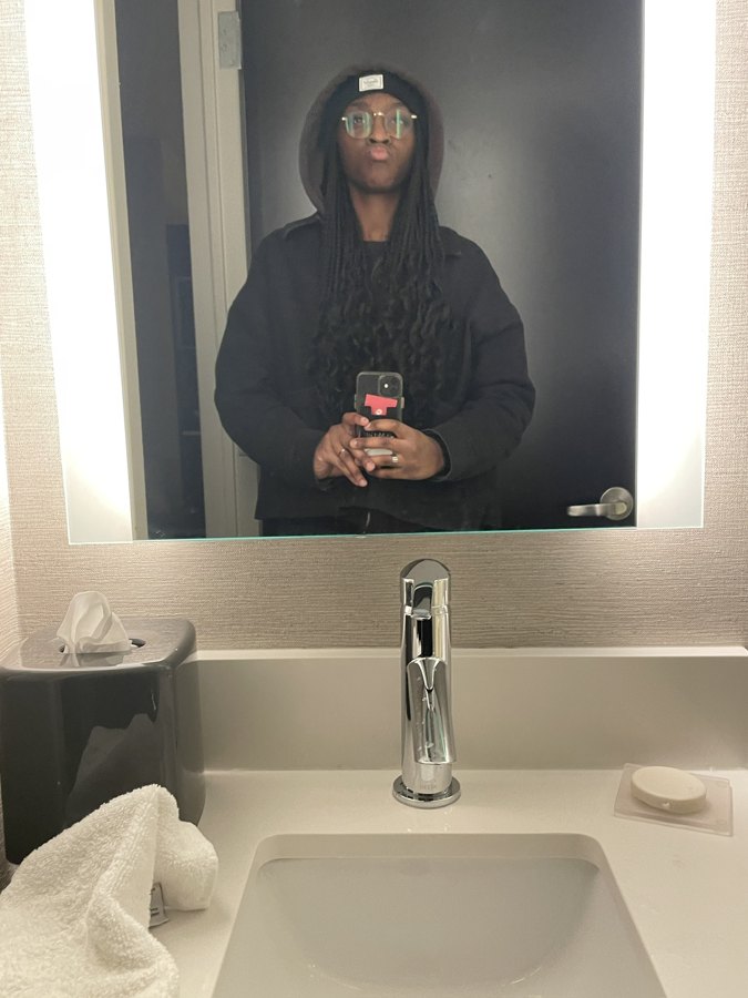 a mirror selfie of me in a beanie and glasses, phone in hand.